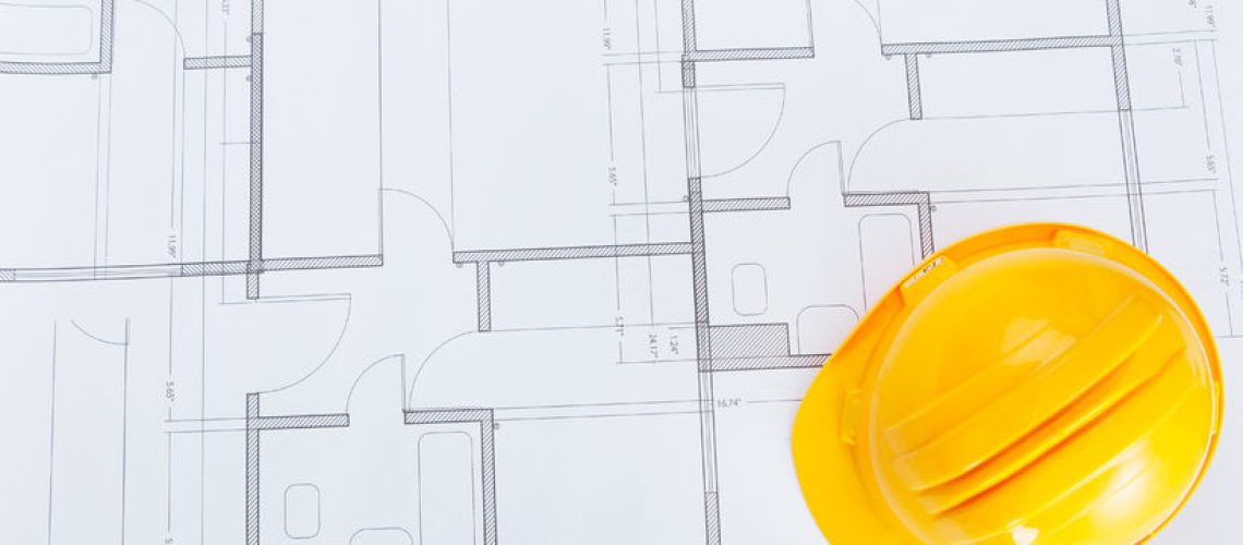 25340095 - close-up photo of hardhat on blue print